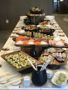 a long table filled with lots of food and desserts on top of it's sides