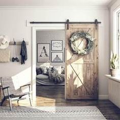 an open door with a wreath on it in a living room next to a chair