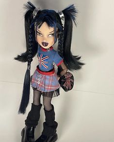 a doll with black hair wearing a blue outfit