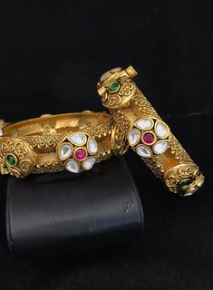 Simply a mark of royalty and elegance!! Handcrafted in brass with gold plating and fine quality Kundan stones. Set of 2 For wrist Size 2.4 Inner Diameter: 2.25 inches Easily Openable with a screw The bangles are the same as shown in the pictures. We have only one piece in this color and design, hence you get what you see in the pictures. Elegant Brass Gold Bracelet For Wedding, Elegant Gold Brass Bracelet For Wedding, Elegant Gold Brass Wedding Bracelet, Elegant Wedding Gold Brass Bracelet, Elegant Gold Jeweled Bangle, Elegant Jeweled Gold Bangle, Antique Gold Jeweled Jewelry For Weddings, Gold Bracelets With Intricate Design For Marriage, Formal Brass Bangle With Intricate Design