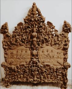 an ornate wooden headboard with carvings on it