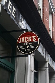 jack's stir brew sign on the side of a building in front of a coffee shop