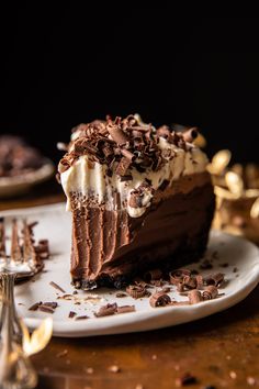 a slice of chocolate cake with whipped cream and chocolate shavings on the top