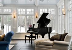 a living room filled with furniture and a grand piano