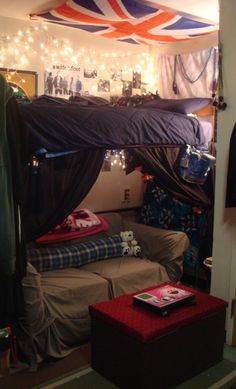 a room with two beds and lights on the ceiling above them, one bed has a canopy over it