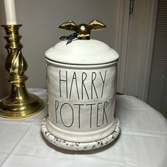 a harry potter canister sitting on top of a table next to a candle holder