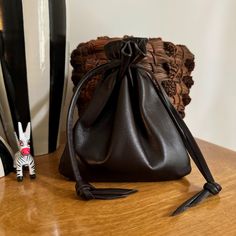 This luscious leather drawstring pouch bag is soft and supple. Made with Dark brown Italian Leather. Drawstring loops slip over your wrist softly. This large sized pouch bag has so many uses. Color - Dark Brown Pouch size Over all is approx -6 1/4" H X 5 1/2" W Pull drawstrings to close at top. Back to shop - http://www.etsy.com/shop/shirlbcreationstoo Leather Drawstring Pouch, Neck Pouch, Pouch Bags, Drawstring Pouch, Money Bag, Purse Pouch, Dark Brown Leather, Best Christmas Gifts, Leather Pouch