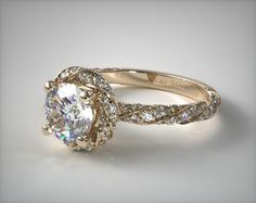 an engagement ring with a large diamond center surrounded by small round diamonds on the band