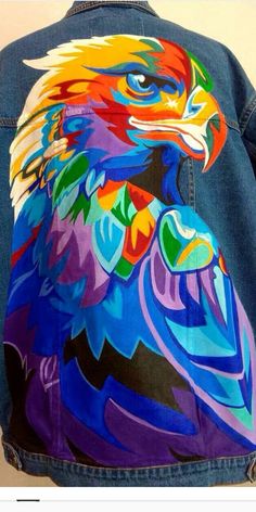 a colorful bird painted on the back of a jean jacket