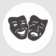 two masks with faces drawn in black on a white round sticker that says theatre