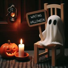 a ghost sitting in a chair next to a lit candle and a sign that says waiting for halloween