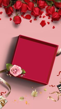 a red box with a rose on it surrounded by ribbons and confetti