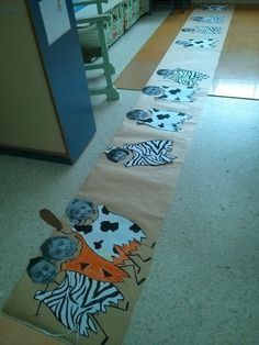 the hallway is decorated with zebras and other animal themed artwork on paper towels that are laid out to make them look like they's going down the aisle