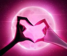 a pink heart shaped object in front of a full moon