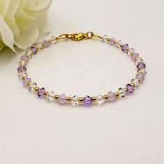 The elegant bracelet features high-quality Czech Crystals and a tasteful design with delicate lavender hues. It showcases 4mm faceted bicone-shaped crystal beads in three distinct colors - clear, lavender, and lavender opal - with gold-colored seed beads in between. You have the option to choose between a 10K gold-plated or 14K gold-filled fully closing lobster-type clasp and jump ring. Wire guards are present on each end of the bracelet to ensure durability. They serve two purposes: 1) inhibiting the wire from wearing down over time, and 2) preventing it from scratching your skin or catching on clothing. This added feature ensures that the bracelet is not only stylish but also comfortable to wear. 📏  See listing photos for sizing help. Enjoy free tracked shipping and a fabric drawstring Handmade Lavender Crystal Bracelet Gift, Elegant Lavender Beaded Bracelets With Faceted Beads, Elegant Lavender Beaded Bracelet With Faceted Beads, Purple Hypoallergenic Crystal Bracelet Gift, Elegant Lavender Bracelets With Faceted Beads, Lavender Beaded Crystal Bracelet As A Gift, Purple Beaded Bracelets For Wedding, Lavender Beaded Crystal Bracelet For Gifts, Elegant Hypoallergenic Purple Beaded Bracelets