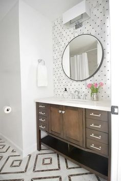 a bathroom with a sink, mirror and tiled floor