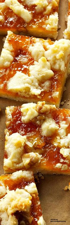 several pieces of pizza sitting on top of a wooden cutting board covered in cheese and sauce