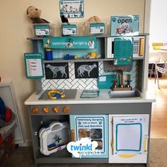 a child's play kitchen with toys on the counter