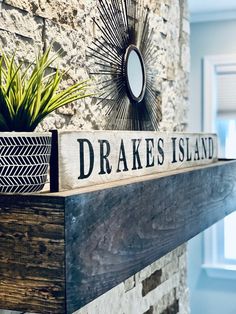 there is a sign that says dreakes island on the mantle in this living room