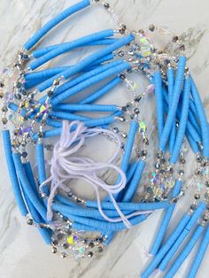 Assorted vinyl beads. Length: 50 inches. Five strands per each design. Total strands 30. Blue Wooden Beads For Festival, Blue Beaded Necklaces With Large Heishi Beads, Ashley Richardson, Star Vinyl, Wholesale Beads, Ghana, Glow In The Dark, Turquoise Necklace, Hair Wrap