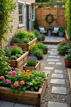 an outdoor garden with lots of plants and flowers in wooden boxes on the side of it