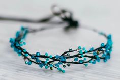 a close up of a headband with blue beads