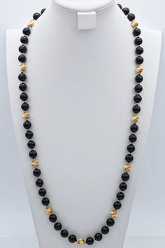 Embrace sophistication with our Vintage 14K Yellow Gold Black Onyx Beaded Strand Necklace. This 35-inch stunner exudes classic charm, making a bold statement in any ensemble. Elevate your style game with this exquisite piece! #VintageJewelry #OnyxNecklace #GoldBeadedStrand Elegant Black Jewelry With 8mm Beads, Elegant Onyx Beaded Necklaces For Formal Occasions, Formal Onyx Necklace With Round Beads, Formal Black Jewelry With Gemstone Beads, Formal Onyx Round Bead Necklaces, Formal Onyx Jewelry With Polished Beads, Formal Onyx Jewelry With Black Beads, Formal Black Gemstone Beads Jewelry, Black Beaded Necklaces For Formal Occasions