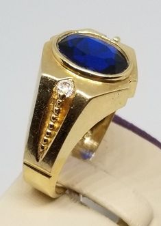 "Vintage 14K Yellow Gold CZ Ring, Size 10. Stamped 14K twice inside band. Blue stone is 10 x 8mm. Weighs 5.4 dwt. Please stop in often as we will be adding additional vintage fine jewelry beauties. Note that the letter/number combo in the title is for our purposes only. We do not check prongs for wear or stones for looseness. All items are sold as is-noting that we are a resale shop so everything here had a previous owner! We will include flaws in the description when noted. This is one of the r Classic Formal Signet Ring With Accent Stones, Formal Gold Signet Ring With Accent Stones, Gold Signet Ring With Accent Stones For Formal Occasions, 14k Gold Sapphire Signet Ring For Anniversary, Classic Yellow Gold Signet Ring With Accent Stones, Oval Signet Ring With Prong Setting For Formal Events, Oval Signet Ring With Prong Setting For Formal Occasions, Formal Sapphire Rings Stamped 14k, Gold Signet Ring With Accent Stones For Anniversary