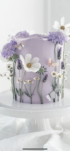 a purple cake with white flowers on it