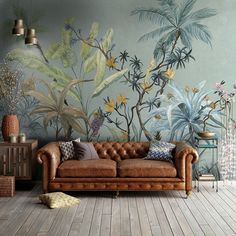 a couch sitting in front of a painting on the wall