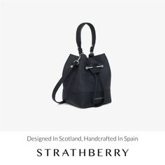 A modern take on the classic bucket bag, our best-selling osette is your perfect everyday companion. Deceptively spacious, the soft structure is handcrafted in spain and features an elegant drawstring closure, complete with our signature music bar. This compact yet versatile silhouette can be carried in hand by the leather top-handle, or styled as a crossbody bag with the detachable leather strap - for elegant ease in your everyday. All of our cashmere is consciously created with the highest lev Music Bar, Charcoal Black, Travel Wallets, Black Charcoal, Leather Top, Handbag Accessories, Black Grey, Bucket Bag, Top Handle