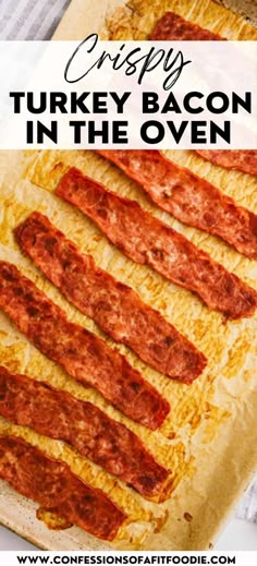 crispy turkey bacon in the oven on a baking sheet with text overlay that says crispy turkey bacon in the oven