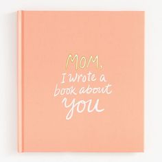 a pink book with the words mom, i wrote a book about you on it