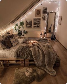 an attic bedroom is decorated with string lights and wooden pallets for the bedding