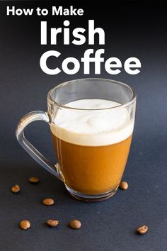 a glass mug filled with coffee sitting on top of a table