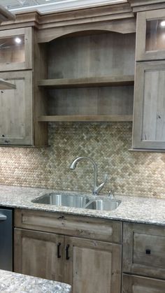 a kitchen with wooden cabinets and marble counter tops