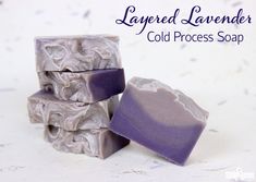 three soap bars stacked on top of each other with the words layered lavender cold process soap