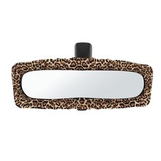 a leopard print mirror hanging on the side of a wall