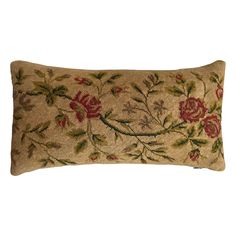 an embroidered pillow with flowers and leaves on the front, sitting on a white background