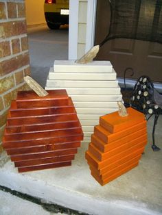 orange and white blocks stacked on top of each other in front of a garage door