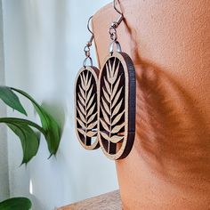 Add a touch of nature-inspired beauty to your look with a pair of botanical fern leaf dangle earrings. 🌿 Our collection of plant-themed jewelry is perfect for plant lovers and a great gift idea for a plant lady or plant mom in your life. The intricate leaf design is cut from eco-friendly cherry wood material and attached to nickel-free, stainless steel hooks. While no metal is considered hypo-allergenic for everyone, stainless steel is often a good choice for people with sensitivities to nickel and other metals.These earrings are big enough to make a statement, yet lightweight enough to be comfortable for all-day wear. See the size information below and in product photos for precise measurements.SIZE INFORMATION 📏Total Earring Drop Length: 2.75" longWood Leaf: 1.75" long x 1" wideYour or Plant Earrings, Wood Dangle Earrings, Jewelry Gift Ideas, Lover Jewelry, Fern Leaf, Unique Plants, Earring Cards, Plant Mom, Themed Jewelry