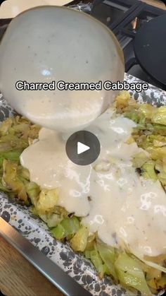 a person pouring gravy on top of a plate of cabbage covered in gravy