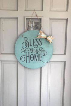 a blue sign hanging on the side of a door that says, bliss is in the home