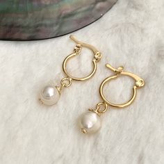 14k Gold-filled Huggie Hoop Earrings With Pearl Charm, Delicate Gold Huggie Earrings With Ear Wire, Small Hoop 14k Gold Filled Pearl Earrings, Gold 14k Gold Filled Huggie Earrings With Pearl Drop, Gold Minimalist Huggie Earrings With Pearl Drop, Minimalist 14k Gold Filled Huggie Earrings With Pearl Charm, Dainty White 14k Gold Filled Huggie Earrings, Gold Small Hoop Pearl Earrings For Everyday, Handmade Gold Huggie Earrings For Wedding