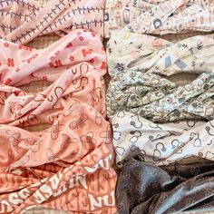 several different colored headbands laying on top of each other in various patterns and sizes