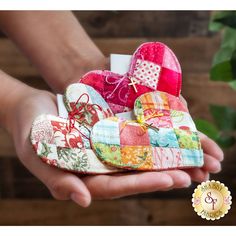 a person holding several heart shaped pieces in their hands