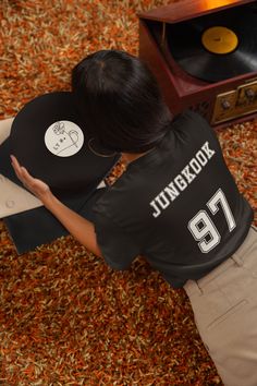 Score big with our BTS Jersey Collection, exclusively designed for the ultimate ARMY! Each jersey-style T-shirt in this collection proudly showcases a BTS member's name on the back, paired with their iconic birth year number, just like a sports legend. Whether you're cheering on BTS at a concert, rocking a casual look, or simply adding to your BTS merch collection, our jersey-style T-shirts are the ultimate way to represent your favorite member. Kpop Style T-shirt With Letter Print And Crew Neck, Kpop Letter Print Crew Neck T-shirt, Kpop Fan Merchandise T-shirt With Crew Neck, Kpop Fan Merchandise Black T-shirt, Black Kpop Fan Merchandise T-shirt, Crew Neck T-shirt With Heat Transfer Vinyl For Fans, Kpop Fan Merchandise Crew Neck Top, Kpop Crew Neck Top Fan Merchandise, Bts Members Names