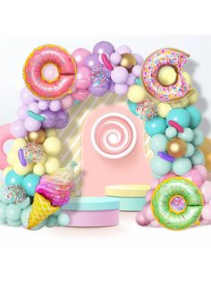 the balloon arch is decorated with donuts, balloons and doughnuts in pastel colors