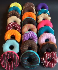 several doughnuts with different colored frosting and sprinkles