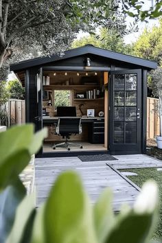 Outdoor office shed with modern decor, black desk, and ergonomic chair. Modern Shed Ideas, Garden Shed Colours, Office Shed Ideas, Backyard Office Shed, Black Shed, Office Shed, Shed Office, Garden Home Office